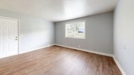 Located at 1351 Avondale Dr in Clarksville, Tennessee, this single-story, 2-bedroom, 1-bathroom home offers a clean and functional layout with consistent design elements throughout. Warm wood-look flooring runs through every room, complemented by soft gray walls and crisp white trim and doors, creating a cohesive, neutral aesthetic.

The combined kitchen and living area forms the heart of the home. The kitchen is equipped with warm oak cabinetry, granite-patterned laminate countertops, a double sink, and white appliances including a refrigerator, electric range, and dishwasher. A range hood is positioned above the stove, and ample upper cabinet storage keeps the space practical.

Both bedrooms are bright and well-proportioned, each featuring large windows that invite natural light and offer views of the surrounding greenery. The primary bedroom includes a double-door closet for generous storage. The second bedroom also benefits from a large window, filling the room with sunlight.

The bathroom is neatly appointed with a pedestal sink, a mirrored medicine cabinet, a toilet, and a tub-shower combination with grab bars, all set on wood-look flooring matching the rest of the home.

The living area provides an open and adaptable space with a front entry door and direct access to the rest of the layout, making this home efficient and easy to navigate.