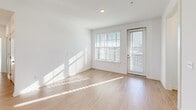 Located at 1700 Ranch Rd in Nokomis, Florida, this two-story home offers a well-organized layout spread across two levels. The ground floor houses an attached garage with an automatic opener and a staircase leading up to the main living areas, which occupy the upper floor.

The upper level is where the home truly opens up, featuring a combined dining room, kitchen, and living room that creates a cohesive, open-concept gathering space. Light wood-style flooring flows throughout the common areas and staircases, lending a clean, contemporary feel. The kitchen is complemented by a dedicated pantry fitted with wire shelving for generous storage. A separate laundry area and hallway round out the functional spaces on this floor.

The two bedrooms are carpeted and filled with natural light from large windows. The primary bedroom includes a ceiling fan and connects to a walk-in closet with wrap-around wire shelving. Additional closets throughout the home provide ample storage. The two bathrooms are finished with wood-look flooring, white subway tile tub-and-shower surrounds, and granite-topped vanities.

Outside, the property enjoys open, sunny surroundings with manicured lawn areas and expansive rural views — a hallmark of Nokomis's relaxed, spacious character.