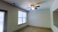 Located at 1040 Wake Towne Dr in Raleigh, NC, this single-floor residence offers a clean, functional layout designed for comfortable everyday living. The interior is finished with warm hardwood-style flooring that runs throughout the space, complementing the neutral, light-toned walls that create a bright and welcoming atmosphere. Natural light flows generously through sizable windows dressed with horizontal blinds, allowing residents to control brightness and privacy with ease. Ceiling fans with integrated lighting fixtures are present in the living areas, providing both practical air circulation and ambient illumination. The overall design is straightforward and well-maintained, with smooth walls, clean baseboards, and standard ceiling heights that give each room an open, airy feel. The single-floor layout ensures easy accessibility and seamless flow between spaces. The understated color palette and simple finishes offer a versatile backdrop suitable for a variety of interior styles. Positioned in Raleigh, NC, the property benefits from its established neighborhood setting, making it a practical and comfortable option for those seeking a no-fuss, move-in-ready space in a convenient location.