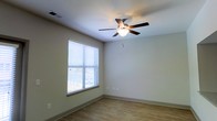 Located at 1040 Wake Towne Dr in Raleigh, NC, this single-floor residence offers a clean, functional layout designed for comfortable everyday living. The interior is finished with warm hardwood-style flooring that runs throughout the space, complementing the neutral, light-toned walls that create a bright and welcoming atmosphere. Natural light flows generously through sizable windows dressed with horizontal blinds, allowing residents to control brightness and privacy with ease. Ceiling fans with integrated lighting fixtures are present in the living areas, providing both practical air circulation and ambient illumination. The overall design is straightforward and well-maintained, with smooth walls, clean baseboards, and standard ceiling heights that give each room an open, airy feel. The single-floor layout ensures easy accessibility and seamless flow between spaces. The understated color palette and simple finishes offer a versatile backdrop suitable for a variety of interior styles. Positioned in Raleigh, NC, the property benefits from its established neighborhood setting, making it a practical and comfortable option for those seeking a no-fuss, move-in-ready space in a convenient location.