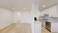Located at 910 Camino Pescadero in Goleta, California, this well-appointed one-bedroom, one-bathroom unit offers a clean, modern aesthetic throughout its efficiently designed single-floor layout. Light wood-look flooring flows seamlessly across every room, creating a cohesive and bright atmosphere. The open living area welcomes natural light through multiple windows dressed with blinds, offering views of surrounding palm trees and greenery. Recessed lighting complements the natural light, keeping the space feeling open and airy. The galley-style kitchen is a standout feature, showcasing floor-to-ceiling white cabinetry with brushed nickel hardware, marble-look countertops and backsplash, and a full suite of stainless steel appliances including a gas range, microwave, refrigerator, and dishwasher. The bedroom is a comfortable, well-lit retreat with a large double sliding-door closet and a window that frames lush outdoor foliage. The bathroom is elegantly finished with marble-look tile extending from floor to ceiling in the walk-in glass-enclosed shower, a white vanity with matching marble countertop, and wood-look tile flooring. A hallway connects the rooms, adding a sense of privacy and flow to this thoughtfully updated unit in the coastal Santa Barbara area.
