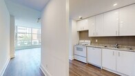 Located at 55 Charles Street West in the heart of Toronto's vibrant Church-Wellesley neighbourhood, this two-bedroom, one-bathroom unit offers a well-designed single-floor layout with a generous total living area. The space is finished with warm hardwood-style flooring throughout the main living areas and bedrooms, complemented by clean white walls that create a bright, neutral palette.

The living areas are highlighted by expansive floor-to-ceiling corner windows that flood the rooms with natural light and frame views of the surrounding Toronto cityscape, including tree-lined courtyards and mid-rise architecture. The open sightlines between the living spaces enhance the sense of roominess and flow.

Both bedrooms are well-proportioned, with the primary bedroom offering a comfortable footprint and mirrored sliding closet doors that add depth to the room. The second bedroom also features mirrored closet storage. A dedicated closet provides additional storage for the unit.

The bathroom is finished in white tile with a vanity featuring a granite-style countertop, white cabinetry, and a well-lit mirror. Track lighting in the hallway adds a modern touch, while a programmable thermostat ensures year-round comfort. The layout includes multiple hallways connecting the rooms efficiently, making the overall flow of the unit practical and intuitive.