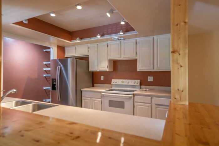 Open kitchen with custom wood bar. - 5482 S Springtree Ln