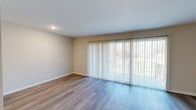 Located at 450 Briar Lane NE in Grand Rapids, Michigan, this one-bedroom, one-bathroom unit offers a well-organized single-floor layout designed for comfortable everyday living. The open-concept living room is a bright and inviting space, featuring durable wood-style flooring, neutral walls, and a large sliding glass door dressed with vertical blinds that opens to a private balcony overlooking a green outdoor setting, filling the room with natural light.

The kitchen flows directly from the living area and is well-appointed with rich dark wood cabinetry, light granite-style countertops, a classic white subway tile backsplash, and a full suite of stainless steel appliances including a gas range, microwave, and refrigerator. A breakfast bar peninsula provides additional counter space and connects the kitchen to the living area.

The bedroom is a generous, carpeted retreat with a natural window view and a built-in closet system offering ample organization and storage. The full bathroom features a matching dark wood vanity with a granite-style countertop, a tub-shower combination with white tile flooring, and a clean, well-lit layout. A hallway connects the main living spaces efficiently. Overall, the unit presents a cohesive, updated aesthetic throughout.