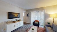 Located at 6701 Carnation St in Richmond, Virginia, this single-floor residence offers a thoughtfully designed layout that balances comfort and functionality. The living area is bright and welcoming, featuring rich hardwood-style flooring, a large sliding glass door fitted with vertical blinds that allows abundant natural light to pour in, and a gallery wall arrangement that adds a personal touch to the space. The adjacent dining area is defined by a dark wood table set beneath a modern track light fixture, complemented by warm neutral walls and additional framed artwork. The kitchen is equipped with warm wood cabinetry, dark granite-style countertops, a double stainless steel sink, and black appliances, with a window providing natural ventilation and light. The bedrooms offer carpeted flooring for added comfort, large windows with views of the surrounding greenery, and ample space for storage and furnishings. The bathrooms feature wood-toned vanity cabinetry, clean white fixtures, and a tub-shower combination. Throughout the residence, a consistent neutral color palette and hardwood-style flooring in the main living areas create a cohesive and modern aesthetic, making this Richmond home a comfortable and practical living space.