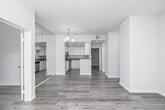 This contemporary 750 square foot apartment in Los Angeles boasts a thoughtful layout with two bedrooms and two bathrooms. The interior showcases a fresh, modern aesthetic with light-toned wood flooring throughout. The open-concept living area features a cozy fireplace and large sliding glass doors, allowing ample natural light and offering views of the surrounding area.

The kitchen is a highlight, with sleek white cabinetry, stainless steel appliances, and quartz countertops, creating a bright and efficient cooking space. Both bathrooms are tastefully designed with modern fixtures, including glass-enclosed showers and stylish tile work.

The bedrooms are generously sized, with the primary bedroom measuring 160 square feet. Each room is equipped with ample closet space and large windows for natural illumination. The apartment's neutral color palette and clean lines contribute to a sense of spaciousness and tranquility.

Additional features include recessed lighting, vertical blinds for privacy, and a well-organized floor plan that maximizes the use of space. Located at 8715 Burton Way, this apartment offers a perfect blend of style and functionality in the heart of Los Angeles.