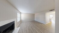 Located at 6267 Salem Cir in Fort Worth, TX, this single-story 2-bedroom, 3-bathroom home offers a well-designed layout with modern finishes throughout. Light wood-look flooring flows seamlessly across the living areas, complemented by neutral-toned walls and textured ceilings that create a bright, welcoming atmosphere.

The spacious living room serves as the heart of the home, anchored by a striking fireplace with a white marble-style surround and hearth. Natural light pours in through blinds-fitted windows, enhancing the open feel. The adjoining dining area and kitchen are open to one another, with the kitchen featuring crisp white cabinetry, quartz countertops, a double-basin sink, and black appliances including a range, over-the-range microwave, and dishwasher. A ceiling fan adds comfort to the dining space, which also benefits from sliding door access to the outdoors.

The primary bedroom offers a comfortable footprint with a ceiling fan and natural light from a well-placed window. The secondary bedroom is similarly bright with its own window. Three bathrooms provide ample convenience, with clean white cabinetry and wood-look tile flooring. Additional highlights include four closets for generous storage, a dedicated laundry area, a hallway connecting key spaces, and a private patio for outdoor enjoyment.