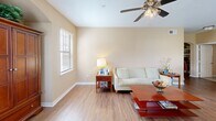 Located in Gonzales, Louisiana, this single-story 2-bedroom, 2-bathroom home offers a functional and well-designed layout across a comfortable footprint. The living room welcomes with warm-toned walls, wood-look flooring, a ceiling fan with light fixture, and multiple windows that invite natural light. An arched built-in niche adds an architectural touch to the space.

The kitchen is equipped with oak cabinetry, granite-style countertops, stainless steel appliances including a range and refrigerator, and a large window overlooking the outdoors. It flows naturally into a dining area, making it ideal for everyday living.

The spacious primary bedroom features plush carpeting, a ceiling fan, and ample natural light from a window. It connects to a walk-in closet outfitted with wire shelving on multiple walls, providing generous storage. The primary bathroom includes a long vanity with granite-style countertop, oak cabinetry, a large mirror, and tile flooring. The second bathroom features a tub-shower combo with a curtain rod, tile flooring, and overhead cabinetry. The second bedroom is also carpeted and well-proportioned. A hallway connects the rooms cohesively, completing this practical and comfortable home.