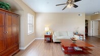 Located in Gonzales, Louisiana, this single-story 2-bedroom, 2-bathroom home offers a functional and well-designed layout across a comfortable footprint. The living room welcomes with warm-toned walls, wood-look flooring, a ceiling fan with light fixture, and multiple windows that invite natural light. An arched built-in niche adds an architectural touch to the space.

The kitchen is equipped with oak cabinetry, granite-style countertops, stainless steel appliances including a range and refrigerator, and a large window overlooking the outdoors. It flows naturally into a dining area, making it ideal for everyday living.

The spacious primary bedroom features plush carpeting, a ceiling fan, and ample natural light from a window. It connects to a walk-in closet outfitted with wire shelving on multiple walls, providing generous storage. The primary bathroom includes a long vanity with granite-style countertop, oak cabinetry, a large mirror, and tile flooring. The second bathroom features a tub-shower combo with a curtain rod, tile flooring, and overhead cabinetry. The second bedroom is also carpeted and well-proportioned. A hallway connects the rooms cohesively, completing this practical and comfortable home.