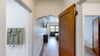 Located at 702 Martin Luther King Jr Way in Tacoma, WA, this well-organized one-bedroom, one-bathroom unit on the third floor offers an efficient and thoughtfully laid-out living space. Light-toned hardwood-style flooring flows seamlessly throughout, lending warmth and cohesion to every room.

The generously sized bedroom comfortably accommodates a full sleeping area and a seating nook, and is brightened by a large window and a ceiling fan overhead. A charming arched doorway connects the bedroom to the dedicated dining area, which features its own window with natural light and ample room for a dining table and chairs.

The kitchen is equipped with white cabinetry, butcher block countertops, a stainless steel sink, and in-unit laundry, making the most of the available space with practical storage solutions. A spacious walk-in closet off the bedroom provides generous shelving and hanging storage.

The bathroom features classic hex tile flooring, a pedestal sink, a mirrored medicine cabinet, and a full bathtub, all framed by crisp white walls and a warm wood door. A hallway connects the rooms, enhancing the overall flow of this compact yet complete home.