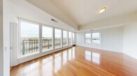Located in Elgin, Illinois, this well-appointed 3-bedroom, 3-bathroom residence offers an elevated living experience with sweeping views of the Fox River and the surrounding cityscape. The open-concept living room is an immediate standout, featuring gleaming hardwood floors, soaring ceilings, and a dramatic wall of floor-to-ceiling windows that flood the space with natural light. A private balcony accessed from the living area provides breathtaking panoramic river views, making it an ideal spot for relaxing or entertaining. The kitchen is thoughtfully designed with rich, dark wood cabinetry, granite countertops, a double stainless steel sink, and a stainless steel dishwasher, all complemented by ample natural light from a large window overlooking the city. The three bedrooms are comfortably sized, with plush carpeting, generous windows offering city views, and convenient closet access. The primary bedroom is a spacious retreat with room for a full suite of furnishings. The three bathrooms are well-finished, with at least one featuring floor-to-ceiling stone tile and a glass-enclosed walk-in shower. Two hallways with hardwood flooring connect the spaces seamlessly, and three closets provide ample storage throughout this refined urban residence.
