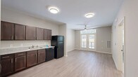 Located at 3345 Kensington Rd in Decatur, GA, this single-story one-bedroom, one-bathroom unit offers a thoughtfully designed layout across a compact yet functional floor plan. Light wood-style flooring runs throughout, complementing the neutral, warm-toned walls that create a clean and cohesive aesthetic.

The open-concept kitchen and living area serves as the heart of the unit. The kitchen is equipped with rich dark-brown shaker-style cabinetry, granite-look countertops, a stainless steel range, a dishwasher, and a full-size refrigerator. The living area extends naturally from the kitchen and is illuminated by flush-mount ceiling lights and a ceiling fan. French doors with transom windows lead to a private patio, filling the space with natural light and outdoor views.

The bedroom is a comfortable, quiet retreat featuring a ceiling fan, a window with blinds, and access to a dedicated closet. The full bathroom includes a tub-shower combo with white subway tile surround, a dark-cabinetry vanity with granite-look countertop, and tile flooring. A separate laundry room provides added convenience with hookups for a full-size washer and dryer and wire shelving for storage. This unit offers a practical and modern living experience in the Decatur area.