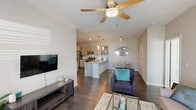This single-story residence in Westlake, Louisiana, offers a thoughtfully designed open-concept floor plan encompassing three bedrooms, two bathrooms, a dedicated office, and an in-unit laundry room. Dark hardwood-style flooring flows throughout, providing a cohesive and polished aesthetic.

The kitchen is a standout feature, showcasing light wood cabinetry, granite countertops, a classic white subway tile backsplash, stainless steel appliances, and a central island with built-in shelving. Pendant lighting and recessed fixtures illuminate the space effectively. The kitchen opens directly to the dining area—accented by track lighting—and the living room, which features a ceiling fan, access to an exterior door, and an abundance of natural light.

The spacious primary bedroom includes ceiling fan, natural light from dual windows, and convenient access to a full bathroom featuring granite countertops and matching cabinetry. Two additional bedrooms provide flexible accommodations. The dedicated office offers a quiet workspace with a large window overlooking the outdoors. The laundry room houses side-by-side full-sized washer and dryer units, adding everyday convenience to this well-rounded residence.