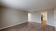 Located at 3775 Houston Ave in Macon, Georgia, this single-story 1-bedroom, 2-bathroom home offers a thoughtfully arranged layout with clean, updated finishes throughout. The open living room is a standout feature, showcasing rich hardwood-style plank flooring, neutral gray walls, crisp white baseboards, and a ceiling vent for climate control. Natural light filters in through a large window, creating a bright and welcoming atmosphere that flows seamlessly into the adjacent kitchen. The kitchen is well-appointed with white shaker-style cabinetry, granite-look countertops, a stainless steel sink, and black appliances including an electric range with overhead ventilation. A window above the counter adds additional natural light to the space. The bedroom is a comfortable, well-proportioned room with the same hardwood-style flooring, a large window overlooking the outdoors, and access to ample closet storage, including a walk-in closet with shelving. Both bathrooms are finished with care — one features mosaic tile flooring, a granite-top vanity with white cabinetry, and access to a tiled tub-shower combo with a window. Additional highlights include a hallway, utility room, and multiple closets, providing generous storage throughout this efficiently designed home.