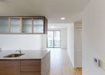 Located at 1500 Miami Pl in the heart of Miami, FL, this contemporary single-floor residence showcases a clean, modern design with an emphasis on natural light and urban views. Light-toned hardwood-style flooring flows throughout the space, creating a seamless and cohesive aesthetic.

The open-concept kitchen is a standout feature, equipped with stainless steel appliances including a refrigerator, microwave, and range. Rich walnut-toned cabinetry is complemented by upper glass-front cabinets with sleek aluminum frames, offering both style and storage. A generous granite-topped island with an undermount sink serves as the centerpiece, providing ample prep space and a natural gathering point.

The living area is bright and airy, anchored by floor-to-ceiling sliding glass doors that open to a balcony with sweeping Miami skyline views. The bedroom similarly benefits from large windows and sliding glass access to the outdoors, filling the room with abundant natural light and city panoramas.

The bathroom is finished with marble-style tile in the tub and shower surround, paired with a granite vanity top and warm wood cabinetry, creating an elegant and functional space.

Throughout the residence, white walls, recessed lighting, and thoughtful storage solutions—including louvered closet doors—contribute to a polished, move-in-ready environment with a distinctly contemporary urban character.