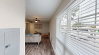 Located at 9312 Beck Avenue in Dallas, TX, this single-story, one-bedroom, two-bathroom home offers a thoughtfully designed layout that maximizes its compact footprint. The interior is unified by durable wood-look plank flooring and a consistent neutral color palette that lends a clean, modern aesthetic throughout.

The living room serves as the heart of the home, offering a comfortable and open gathering space with a ceiling fan overhead, crisp white baseboards, and a seamless sightline toward the kitchen pass-through. The space accommodates seating and casual furnishings with ease.

The bedroom is a well-proportioned retreat featuring warm neutral wall tones, a ceiling fan with light fixture, a window that invites natural light, and direct access to a dedicated closet. The calm, understated design creates a restful atmosphere.

Both bathrooms are finished with contemporary details. The full bathroom adjacent to the bedroom features large-format tile surrounding a soaking tub and shower combination, white cabinetry with a light countertop, and matte black hardware accents that add a refined touch.

Throughout the home, consistent finishes—including panel-style doors, neutral walls, and wood-look flooring—create a cohesive and inviting environment. The efficient single-level layout ensures easy flow between all rooms, making this Dallas home a practical and comfortable living space.