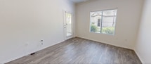 Located at 7990 E Snyder Rd in Tucson, Arizona, this two-bedroom, one-bathroom single-floor residence offers a well-organized layout designed for comfortable, everyday living. The open-concept kitchen and living area serves as the heart of the home, where wood-look flooring flows throughout. The kitchen stands out with dark espresso cabinetry, light quartz-style countertops, a herringbone tile backsplash, stainless steel appliances including a range and microwave, and an arched window that fills the space with natural light. A peninsula counter connects the kitchen to the living area, enhancing the open feel.

The living room features crown molding, a ceiling fan, and a window overlooking greenery. The primary bedroom continues the wood-look flooring, includes a ceiling fan, and offers views of surrounding trees through multiple windows. The second bedroom is carpeted and features a sliding glass door that opens directly to a private enclosed patio shaded by mature trees. The bathroom is clean and functional, with wood-look tile flooring, a tub-shower combo, and a vanity. A dedicated in-unit laundry area with shelving adds everyday convenience, completing this practical and well-appointed Tucson residence.