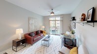 Located at 312 N Hill St in Mishawaka, Indiana, this single-floor residence offers a thoughtfully designed layout with contemporary finishes throughout. The kitchen is a standout space, featuring crisp white cabinetry extending to the ceiling, granite countertops, a tile backsplash, stainless steel appliances including a refrigerator, range, and microwave, and wood-look flooring. A generous island provides additional prep and dining space, while recessed and pendant lighting complete the polished look.

The living area is bright and welcoming, with a ceiling fan, large sliding glass doors opening to a private balcony, and views of the surrounding community. The open layout comfortably accommodates both a seating and dining arrangement.

The primary bedroom features plush carpeting, a ceiling fan, a window with natural light, and direct access to an en-suite bathroom. The bathroom includes a glass-enclosed shower, granite vanity, dark wood-look flooring, and leads to a dedicated walk-in closet. A second bedroom offers carpet, ceiling fan, two windows, and its own character. A second bathroom with a soaking tub and walk-in closet provides added convenience, rounding out this well-balanced and modern residence.