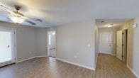 This single-story, 3-bedroom, 2-bathroom home delivers a practical and comfortable layout designed for everyday living. The main living area features warm wood-look plank flooring, neutral gray walls, and a ceiling fan, creating a bright and inviting atmosphere. A dedicated dining area with matching flooring flows seamlessly from the living space, offering an open connection to the kitchen.

The kitchen is a standout feature, equipped with dark espresso cabinetry, granite-style countertops, a double basin sink, and black appliances including a refrigerator, range, and microwave. A convenient pass-through layout connects the kitchen to additional living areas, and a dedicated laundry space is accessible directly from the kitchen.

The bedrooms are carpeted for comfort and each include ceiling fans and closets. The two bathrooms are finished with tile flooring, dark vanity cabinetry, granite-style countertops, and well-lit mirrors. One bathroom features a shower-tub combination.

Throughout the home, clean white trim, consistent neutral tones, and efficient use of space contribute to a cohesive and move-in-ready aesthetic. The thoughtful floor plan ensures smooth traffic flow between all areas of the home.