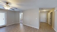 This single-story, 3-bedroom, 2-bathroom home delivers a practical and comfortable layout designed for everyday living. The main living area features warm wood-look plank flooring, neutral gray walls, and a ceiling fan, creating a bright and inviting atmosphere. A dedicated dining area with matching flooring flows seamlessly from the living space, offering an open connection to the kitchen.

The kitchen is a standout feature, equipped with dark espresso cabinetry, granite-style countertops, a double basin sink, and black appliances including a refrigerator, range, and microwave. A convenient pass-through layout connects the kitchen to additional living areas, and a dedicated laundry space is accessible directly from the kitchen.

The bedrooms are carpeted for comfort and each include ceiling fans and closets. The two bathrooms are finished with tile flooring, dark vanity cabinetry, granite-style countertops, and well-lit mirrors. One bathroom features a shower-tub combination.

Throughout the home, clean white trim, consistent neutral tones, and efficient use of space contribute to a cohesive and move-in-ready aesthetic. The thoughtful floor plan ensures smooth traffic flow between all areas of the home.