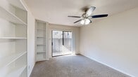 Located on Cypresswood Drive in Spring, TX, this single-story, one-bedroom, one-bathroom unit offers a practical and well-organized layout across a compact but functional floor plan. The combined kitchen and living area serves as the heart of the unit, where the galley-style kitchen features warm wood-toned cabinetry, granite-look countertops, a white appliance suite including a range, microwave, and refrigerator, and durable wood-look flooring. A peninsula counter provides a natural transition into the carpeted living area, which is brightened by a ceiling fan with light fixture and built-in shelving that adds convenient display and storage space. A sliding glass door opens to an outdoor patio, inviting natural light and outdoor access. The bedroom is generously proportioned, finished with plush carpeting, a ceiling fan, and a window with blinds that allows for natural light. It connects conveniently to a dedicated closet and provides easy access to the hallway. The full bathroom features a tub/shower combination with tiled surround, a wood-vanity with granite-look countertop, and wood-look flooring. Additional storage is provided by a pantry, making the overall layout notably efficient and well-appointed for everyday living.