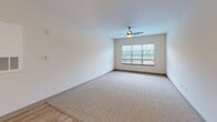 This 990 square foot apartment in Kernersville, NC offers a thoughtful layout with two bedrooms and two bathrooms. The primary bedroom, measuring 160 square feet, provides ample space for comfort. The modern kitchen is a standout feature, boasting rich wood cabinetry, granite countertops, and stainless steel appliances, including a built-in microwave. The open concept living and dining area is illuminated by large windows and enhanced by a ceiling fan.

Both bedrooms are carpeted for comfort and feature windows for natural light. The bathrooms are equipped with modern fixtures, including a combination tub-shower, and vanities with granite countertops. Storage solutions include wire shelving in the closets.

The apartment's neutral color palette, with white walls and beige carpeting in the bedrooms, creates a bright and airy atmosphere. Wood-look flooring in the common areas adds warmth and durability. The overall design prioritizes functionality and modern aesthetics, making efficient use of the available space.