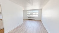 Located at Patricia Ave in Kitchener, Ontario, this well-appointed one-bedroom, one-bathroom unit offers a thoughtfully designed layout across a single floor. The interior has been finished with light-toned vinyl plank flooring throughout, creating a cohesive and modern aesthetic that enhances the sense of space and brightness.

The living room is a welcoming open area with crisp white walls, clean baseboards, and a textured ceiling. A front entry door opens directly into this space, which connects seamlessly to the rest of the unit via a central hallway. The hallway provides access to a closet, offering practical storage solutions.

The bedroom is a comfortable, well-proportioned room featuring a large window that allows generous natural light to fill the space. A baseboard radiator provides efficient heating, and the neutral palette creates a calm, restful atmosphere with views of the surrounding neighbourhood.

The bathroom is finished with classic white subway tile surrounding the soaker tub and shower combination, complemented by chrome fixtures, a pedestal-style sink, and a well-lit vanity mirror — delivering a clean, timeless look.

Throughout the unit, the consistent use of light tones, modern flooring, and bright windows creates an airy and inviting ambiance, making this a functional and attractive space in the heart of Kitchener.