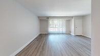 Located at 2607 Welsh Rd in Philadelphia's 19114 neighborhood, this well-appointed one-bedroom, one-bathroom unit offers a thoughtfully designed single-floor layout. The open-concept living and dining area is highlighted by light hardwood-style flooring, neutral toned walls, and a large sliding glass door dressed with vertical blinds that flood the space with natural light and provide outdoor views. The kitchen is outfitted with dark espresso cabinetry, quartz countertops, a stainless steel sink, black appliances including a gas range and over-the-range microwave, and a decorative mosaic tile backsplash that adds a modern touch. A dedicated entryway with light wood flooring provides a clean transition into the main living area. The generously sized primary bedroom features plush wall-to-wall carpeting, a natural window view, and mirrored sliding closet doors that enhance the sense of space. The full bathroom is finished with classic white subway tile, an accent mosaic border, a soaking tub with shower, a vanity with under-cabinet storage, and a mirrored medicine cabinet, creating a clean and timeless aesthetic throughout.