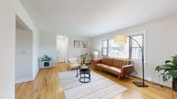 This 3-bedroom, 1-bathroom single-floor residence offers a thoughtfully arranged layout that makes efficient use of its space. Warm hardwood flooring flows consistently throughout the main living areas, lending a cohesive and inviting character to the home.

The living room is bright and open, featuring multiple windows fitted with horizontal blinds that allow generous natural light to fill the space. A neutral color palette on the walls complements the natural tones of the flooring, creating a clean and comfortable atmosphere.

The combined dining and kitchen area is well-appointed, featuring dark cabinetry contrasted against light countertops and stainless steel appliances, including a gas range and over-the-range microwave. A window above the kitchen counter brings in additional natural light, while tile flooring in the kitchen transitions smoothly to hardwood in the dining area.

The primary bedroom is a comfortable, light-filled room with a window overlooking the outdoors and a baseboard heating unit. The hallway provides access to a built-in closet with multi-shelf storage, connecting the bedrooms to the shared full bathroom, which features a tiled shower-tub combination and a window for natural ventilation.

A central hallway ties all rooms together, offering practical flow and additional storage throughout this well-organized home.
