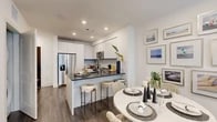 Located at 27942 Forbes Rd in Laguna Niguel, CA, this thoughtfully designed one-bedroom, one-bathroom residence offers a modern aesthetic with high-quality finishes throughout its efficiently utilized single-floor layout. The open-concept kitchen and living area serves as the heart of the home, featuring sleek white flat-front cabinetry that extends to the ceiling, a marble-look tile backsplash, dark quartz countertops, stainless steel appliances including a side-by-side refrigerator, dishwasher, microwave, and range, and a peninsula with bar seating — ideal for casual dining or entertaining. Rich wood-tone flooring runs continuously through the main living areas, grounding the bright, neutral palette. The living room is bathed in natural light from expansive floor-to-ceiling windows that frame outdoor views of palm trees and the surrounding community. The bedroom offers a serene retreat with large windows, a ceiling fan, and a dedicated closet. The bathroom is finished with large-format marble-look tile flooring, a floating vanity with dark countertop, a well-lit mirror, and a tiled soaking tub and shower combination. Recessed lighting throughout enhances the clean, contemporary ambiance of this well-appointed Laguna Niguel residence.