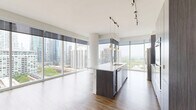 Located at 1407 South Michigan Avenue in Chicago's South Loop, this contemporary 2-bedroom, 2-bathroom residence offers an expansive, thoughtfully designed floor plan with an abundance of natural light throughout. Rich hardwood-style flooring flows seamlessly across the entire unit, complementing the clean white walls and modern aesthetic.

The open-concept living, dining, and kitchen area serves as the heart of the home, anchored by dramatic floor-to-ceiling windows that frame sweeping views of the Chicago skyline and Grant Park beyond. The sleek kitchen features a central island with a waterfall countertop and undermount sink, dark wood cabinetry, stainless steel appliances including a gas range and refrigerator, and stylish pendant lighting — all set against the stunning cityscape backdrop.

The generously sized primary bedroom enjoys its own window view and ample closet space, while the second bedroom offers a bright, versatile layout. Both bathrooms are finished with large-format neutral tiles, dark wood vanities, white countertops, and full tub-shower combinations. Additional highlights include an in-unit laundry area, five closets for abundant storage, a private balcony, and a hallway connecting the well-organized layout. The residence offers a polished, urban living experience in one of Chicago's most vibrant neighborhoods.