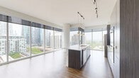 Located at 1407 South Michigan Avenue in Chicago's South Loop, this contemporary 2-bedroom, 2-bathroom residence offers an expansive, thoughtfully designed floor plan with an abundance of natural light throughout. Rich hardwood-style flooring flows seamlessly across the entire unit, complementing the clean white walls and modern aesthetic.

The open-concept living, dining, and kitchen area serves as the heart of the home, anchored by dramatic floor-to-ceiling windows that frame sweeping views of the Chicago skyline and Grant Park beyond. The sleek kitchen features a central island with a waterfall countertop and undermount sink, dark wood cabinetry, stainless steel appliances including a gas range and refrigerator, and stylish pendant lighting — all set against the stunning cityscape backdrop.

The generously sized primary bedroom enjoys its own window view and ample closet space, while the second bedroom offers a bright, versatile layout. Both bathrooms are finished with large-format neutral tiles, dark wood vanities, white countertops, and full tub-shower combinations. Additional highlights include an in-unit laundry area, five closets for abundant storage, a private balcony, and a hallway connecting the well-organized layout. The residence offers a polished, urban living experience in one of Chicago's most vibrant neighborhoods.
