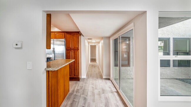 Hallway with kitchen on left and patio on right - 3801 Esplanade