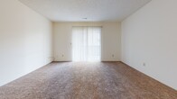 Located at 5700 E Mainsgate Rd in Wichita, Kansas, this single-floor residence offers a practical and comfortable layout designed for everyday living. The living area is generously sized, featuring plush wall-to-wall carpeting and a sliding glass door dressed with vertical blinds that allows natural light to fill the space and provides access to the outdoors. The kitchen is equipped with white appliances including an electric range and dishwasher, complemented by a wood-toned countertop and durable tile flooring. Multiple carpeted bedrooms provide comfortable private retreats, each featuring windows with horizontal blinds that allow for natural light and privacy. Several bedrooms include double-door closets, offering ample storage. Textured ceilings are consistent throughout the home, adding a classic finishing detail. The two full bathrooms each feature a tub-shower combination, toilet, and a wood-toned vanity with an integrated sink set over tile flooring, providing functional and well-appointed spaces. Throughout the home, neutral tones and clean finishes create a cohesive, move-in-ready environment well suited for comfortable residential living in northeast Wichita.