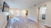 Located at 10710 Beaver Dam Rd in Cockeysville, MD, this thoughtfully designed single-floor unit offers a clean, modern aesthetic throughout. Light wood-tone luxury vinyl plank flooring flows seamlessly across every room, complemented by crisp white crown molding and neutral warm-beige walls that create a bright, welcoming atmosphere.

The open living area is bathed in natural light from multiple windows dressed with white horizontal blinds, and features recessed lighting and a wall-mounted TV bracket. The kitchen is well-appointed with shaker-style gray cabinetry, marble-look countertops, under-cabinet lighting, and a full suite of stainless steel appliances including a range, microwave, dishwasher, and refrigerator.

The bedroom offers a spacious, serene retreat with recessed lighting, crown molding, and direct access to a closet with built-in shelving. Two bathrooms serve the unit; one includes a soaking tub with a subway-tiled surround accented by a decorative taupe border stripe and brushed nickel fixtures.

The utility area includes in-unit laundry with cabinetry and marble-look countertop space above, adding convenience and functionality. Two closets provide ample storage throughout. The overall design is cohesive and move-in ready, reflecting quality finishes in a compact, efficient layout.