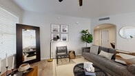 Located in Phoenix, AZ, this well-appointed single-story, 3-bedroom, 2-bathroom home offers a thoughtfully designed layout with modern finishes throughout. The living room welcomes you with vaulted ceilings, light wood-look flooring, and a ceiling fan, creating an open and airy atmosphere. An elegant arched passageway connects the living area to the rest of the home, adding a distinctive architectural detail.

The kitchen is outfitted with white shaker cabinetry, light stone countertops, and stainless steel appliances, including a full-size refrigerator and dishwasher. A bright window fills the space with natural light. Adjacent to the kitchen, the dining area features a charming bay window configuration that floods the room with sunlight, creating an inviting setting.

The primary bedroom is generously sized, featuring vaulted ceilings, plush carpeting, a ceiling fan, and a large window. It connects to a spacious walk-in closet with built-in shelving and hanging rods. The two bathrooms are finished cleanly with wood-look tile flooring, white tilework, and updated vanities. A hallway with arched detailing and recessed lighting connects the bedrooms and baths. Throughout the home, a neutral color palette and consistent finishes create a cohesive, modern aesthetic.