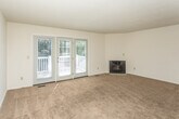 Located at 3145 Lohr Rd in Ann Arbor, Michigan, this three-floor property offers a practical and well-organized layout across its levels. The kitchen is a standout feature, equipped with warm oak cabinetry providing generous storage, white countertops, and a suite of stainless steel appliances including a gas range, refrigerator, dishwasher, and microwave. Durable wood-look flooring runs throughout the kitchen, complementing the functional galley-style design.

The living area is spacious and carpeted, featuring a fireplace and a glass-paneled exterior door flanked by windows that invite natural light and provide views of the surrounding greenery. Additional carpeted rooms serve as comfortable bedrooms, each with windows fitted with blinds to control light.

The bathrooms maintain a clean, understated aesthetic with white vanities, large mirrors, and wood-look flooring. The attached garage provides dedicated parking and storage space, complete with an automatic opener. The basement level houses the mechanical systems, including an electrical panel and a water heater, and offers additional utility space. Overall, the property presents a straightforward and functional design suited for everyday living.