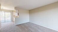 Located at 200 E Brazoswood Drive in Clute, Texas, this single-floor residence offers a practical and well-organized layout designed for comfortable everyday living. The open living area features neutral-toned walls and plush wall-to-wall carpeting, creating a warm and inviting atmosphere. A pass-through kitchen connects seamlessly to the living space and is equipped with white cabinetry, light-toned countertops, a built-in sink with a modern faucet, a dishwasher, an electric range, and a full-size refrigerator. The kitchen features wood-look vinyl flooring and a window that allows natural light to brighten the space. The bedrooms are generously sized, each finished with soft carpeting, ceiling fans, and windows fitted with blinds. The primary bedroom stands out with dual closets, offering ample storage. The bathroom is accessible via a hallway and features wood-look vinyl flooring, a full bathtub with a shower, and clean white fixtures. Throughout the residence, a consistent neutral color palette and clean white trim contribute to a bright, cohesive aesthetic. The single-story layout ensures easy accessibility and effortless navigation between all areas of the home.