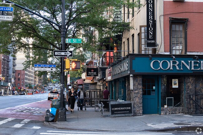 People go about their business on the busy streets of Midtown Manhattan.