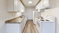 Located in Lakewood, WA, this well-appointed one-bedroom, one-bathroom unit offers a thoughtfully designed single-floor layout with modern finishes throughout. Luxury vinyl plank flooring runs continuously across the entire space, complementing the crisp white walls and textured ceilings that lend a clean, contemporary feel.

The open-concept living, dining, and kitchen area serves as the heart of the unit. The living room is generously proportioned, bathed in natural light from large windows, and opens directly onto a private balcony — ideal for enjoying outdoor views. The galley-style kitchen is efficiently laid out with white shaker cabinetry, granite-look countertops, a stainless sink, and a full suite of white appliances including a range, refrigerator, and dishwasher. An in-unit washer is also conveniently located within the kitchen area.

The spacious bedroom features ample natural light from a window with blinds, baseboard heating, and a notably generous closet arrangement — two sliding-door closets provide substantial built-in storage. Three additional closets elsewhere in the unit further enhance storage capacity.

The bathroom is clean and bright, featuring a full tub/shower combination, a white vanity, and matching LVP flooring. The overall ambiance of the unit is bright, neutral, and move-in ready.