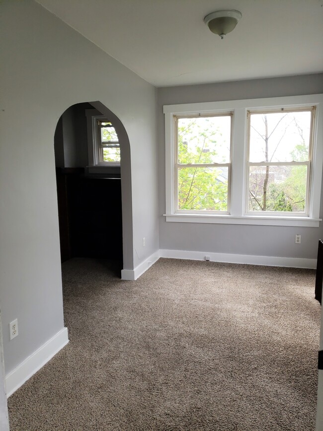 The sun-room enter into the living room through the archway - 201 Richbarn Rd