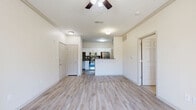Located in the desirable Stone Oak neighborhood of San Antonio, TX, this well-appointed 1-bedroom, 1-bathroom residence offers a thoughtfully designed single-floor layout that maximizes comfort and functionality. The open-concept living area features light wood-style flooring, crown molding, and a ceiling fan, creating a bright and airy atmosphere that flows seamlessly into the kitchen. The kitchen is a standout space, showcasing white cabinetry, dark granite countertops, a bold subway tile backsplash, stainless steel appliances, and a convenient breakfast bar — ideal for both cooking and casual dining. The spacious bedroom is finished with plush carpet, a ceiling fan, and large windows dressed with blinds that invite abundant natural light. The bedroom connects to a generous walk-in closet with wire shelving, providing ample storage. Two additional closets offer even more organizational flexibility. The full bathroom features a dual-sink vanity with dark countertops, white cabinetry, and wood-style flooring. A dedicated in-unit laundry area with washer and dryer adds everyday convenience. A private balcony completes this residence, offering a pleasant outdoor retreat in one of San Antonio's most sought-after locations.