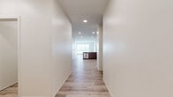Located at 95 Elmwood Ave in Bridgeport, CT, this modern 2-bedroom, 3-bathroom residence offers a thoughtfully designed open-concept layout with high-quality finishes throughout. The combined kitchen and living area forms the heart of the home, featuring light hardwood-style flooring, large windows that flood the space with natural light, and direct access to a private balcony with outdoor views. The kitchen is appointed with warm wood-tone cabinetry, stainless steel appliances, and a striking quartz waterfall island that doubles as a casual dining and entertaining surface. The spacious living area provides a bright, airy atmosphere with generous ceiling height. Both bedrooms are carpeted for comfort, each offering natural light through blinded windows. The primary bedroom is well-proportioned and accompanied by a dedicated walk-in closet featuring wire shelving for ample storage. All three bathrooms are finished in a clean, contemporary style with light wood vanities, quartz countertops, and tiled tub-shower combinations. A dedicated laundry room houses a full-size washer and dryer. Two closets provide additional storage throughout the residence. The exterior showcases a modern brick and panel facade with private balcony decking, set within a landscaped community environment.
