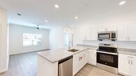 Located at 2709 Pointe North Blvd in Albany, Georgia, this single-story, 3-bedroom, 2-bathroom home offers a well-designed layout with modern finishes throughout. The open-concept kitchen serves as the heart of the home, showcasing crisp white shaker cabinetry, granite countertops with a subtle speckled pattern, a subway tile backsplash, and a full suite of stainless steel appliances including a refrigerator, range, microwave, and dishwasher. A central kitchen island with an undermount sink adds both functionality and style, flowing seamlessly into the living area, which features light wood-style flooring and a ceiling fan.

The bedrooms are bright and comfortable, each equipped with ceiling fans and windows fitted with blinds. The primary bedroom offers plush carpeting, a walk-in closet, and direct access to an en-suite bathroom. Additional bedrooms feature light wood-style flooring. The bathrooms are finished with granite vanity tops and brushed nickel fixtures, with one bath featuring a full tub-shower combination.

A dedicated laundry room provides added convenience with washer/dryer hookups and built-in shelving. The home's clean, neutral palette and consistent use of quality materials create a bright, cohesive living environment throughout.