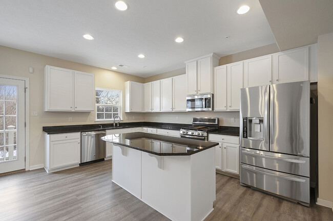 Gourmet Kitchen with upgraded cabinetry, granite counter top and stainless still appliances. - 1201 Pointe View Dr