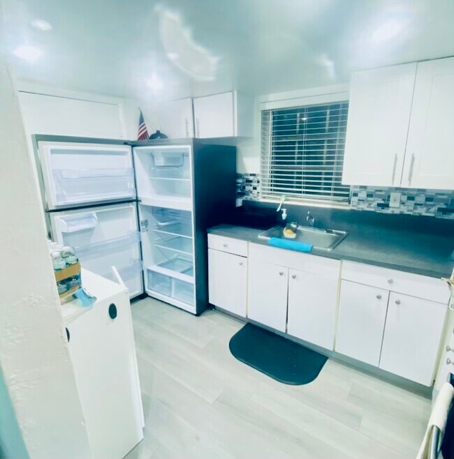 full fridge with Secondary door for unit exit next to it. Plenty of cabinets - 10901 N Kendall Dr