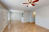 Located at 2001 19th St in Huntsville, Texas, this single-story, 2-bedroom, 1-bathroom home offers a functional and well-organized layout. Light wood-style flooring flows throughout the entire residence, creating a cohesive and clean aesthetic. The open living area is bright and airy, featuring multiple windows with blinds that allow natural light to fill the space, complemented by a ceiling fan for added comfort. The kitchen is thoughtfully designed with white shaker-style cabinetry, white countertops, a stainless steel sink, and white appliances including an electric range and refrigerator. A pass-through peninsula connects the kitchen to the adjacent dining and living areas, enhancing the open feel. A dedicated pantry provides additional storage. The two bedrooms are comfortably sized, each equipped with a ceiling fan and closet access. The primary bedroom offers generous proportions and connects conveniently to the hallway. The full bathroom features a tub-shower combo with brushed nickel fixtures and a clean white surround. Four closets throughout the home ensure ample storage. The neutral color palette and clean finishes give this home a move-in ready appeal.