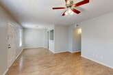 Located at 2001 19th St in Huntsville, Texas, this single-story, 2-bedroom, 1-bathroom home offers a functional and well-organized layout. Light wood-style flooring flows throughout the entire residence, creating a cohesive and clean aesthetic. The open living area is bright and airy, featuring multiple windows with blinds that allow natural light to fill the space, complemented by a ceiling fan for added comfort. The kitchen is thoughtfully designed with white shaker-style cabinetry, white countertops, a stainless steel sink, and white appliances including an electric range and refrigerator. A pass-through peninsula connects the kitchen to the adjacent dining and living areas, enhancing the open feel. A dedicated pantry provides additional storage. The two bedrooms are comfortably sized, each equipped with a ceiling fan and closet access. The primary bedroom offers generous proportions and connects conveniently to the hallway. The full bathroom features a tub-shower combo with brushed nickel fixtures and a clean white surround. Four closets throughout the home ensure ample storage. The neutral color palette and clean finishes give this home a move-in ready appeal.