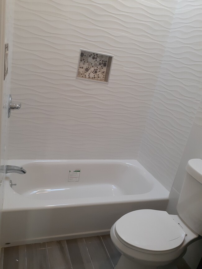 Spacious bathroom. Floor to ceiling tile. Soaking tub. Skylight - 50 Fountain Ave