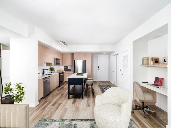 Las cocinas de concepto abierto en Modera Aventura combinan acabados elegantes con la comodidad de un espacio de oficina en casa. - Modera Aventura